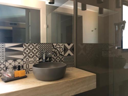 a bathroom with a bowl sink on a counter at Araja Villa&Suite by Geocharme in San Vito lo Capo