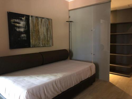 a bedroom with a bed and a glass closet at Araja Villa&Suite by Geocharme in San Vito lo Capo
