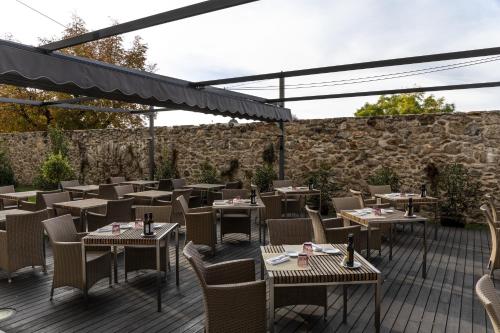 a restaurant with tables and chairs on a patio at Parador de La Granja in La Granja de San Ildefonso