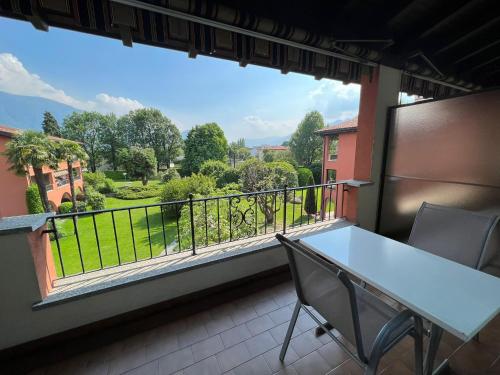 a balcony with a table and chairs and a view at Ascona: Sabrina Apt.238 in Ascona