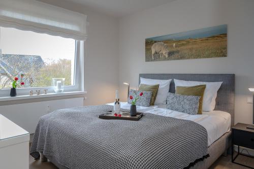 Un dormitorio con una cama y una bandeja. en Schneckenhüs en Westerland