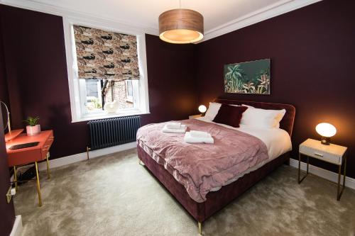 a bedroom with a bed and a desk and a window at Maison Mouettes by Luxury Travel Emporium - Luxury Suites with Abbey Views in Whitby