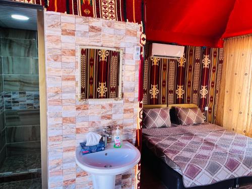 a small room with a sink and a bed at Shakria Bedouin Life Camp in Wadi Rum