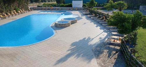 an overhead view of a swimming pool with lounge chairs at Tenuta Don Monaco - Agriturismo in Santa Cesarea Terme