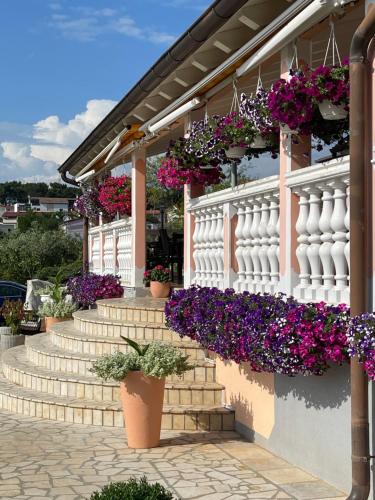 a bunch of flowers on a building with stairs at Villa Natalija in Medulin