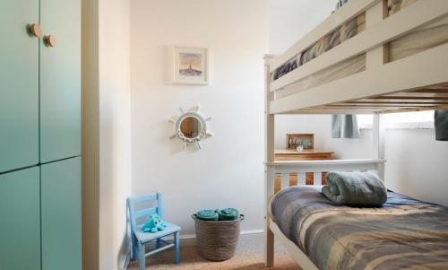 a bedroom with a bunk bed and a ladder at Refurbished Seaside Retreat in the Heart of Cromer in Cromer