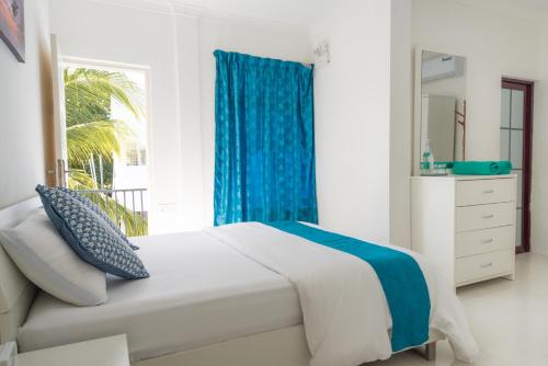 Postel nebo postele na pokoji v ubytování Palm Gate Maldives