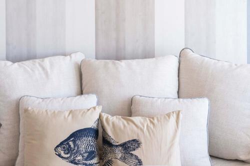 a bunch of pillows sitting on a couch at San Vito Luxury Accomodation in Polignano a Mare