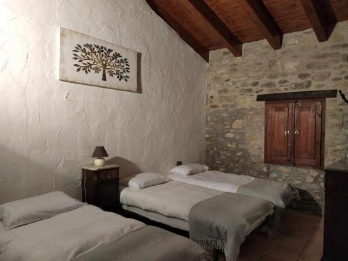 A bed or beds in a room at Mas Planella Casa Rural
