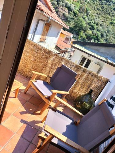 a balcony with a table and chairs on a roof at CASA LEONE BADALUCCO in Badalucco