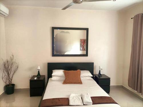 a bedroom with a large bed with two night stands at Portersville Private Lodge in Freetown