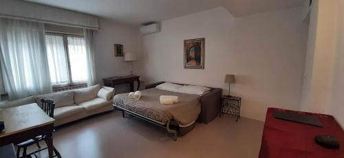 a living room with a bed and a couch at Residence Sole in Trieste