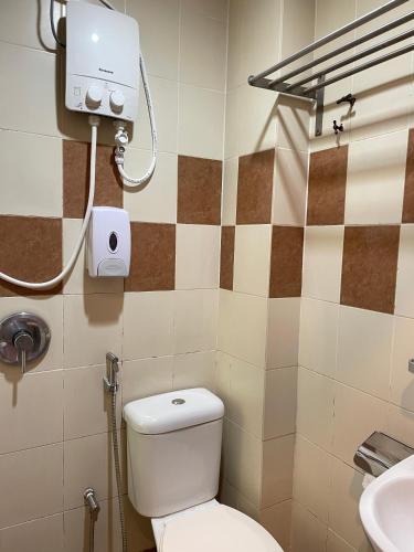 a bathroom with a toilet and a sink at Fresh Hotel Falim in Ipoh