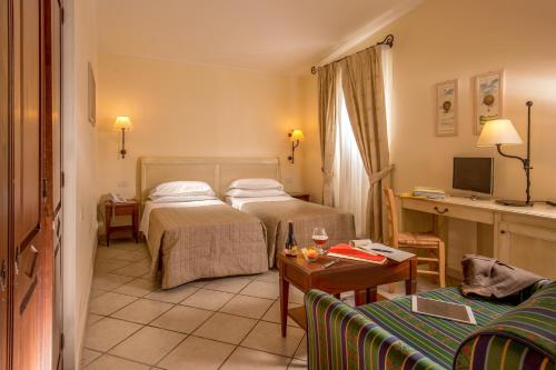 Postel nebo postele na pokoji v ubytování Hotel Selva Candida