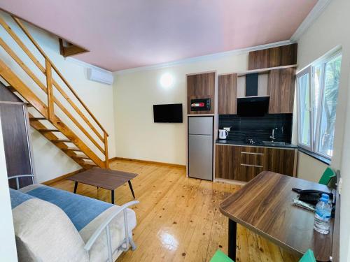a small room with a kitchen and a staircase at Calligraphy Hotel and Cottages in Mtsvane Kontskhi