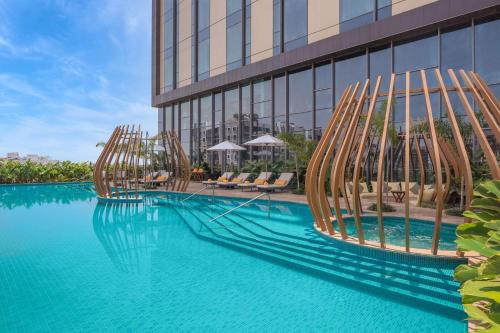 a swimming pool in front of a building at Radisson Blu Hotel & Spa, Nashik in Nashik