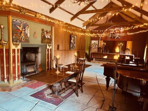 a dining room with a table and a piano at Buittle Castle Exclusive Use- Stay in your own Castle! in Castle Douglas