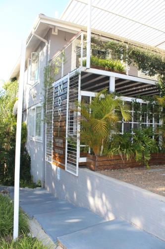 a building with a sign on the side of it at Mogi Boutique Hotel in Ezulwini