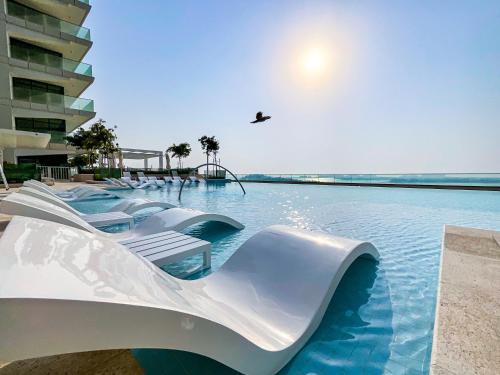 a water slide in a swimming pool at a resort at HiGuests - Superlative apt with private beach access in Dubai
