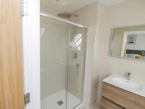 a bathroom with a shower and a sink at Foxton Penthouse in Whitby