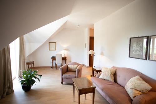 a living room with a couch and a chair at Hotel Restaurant Krone in Hayna