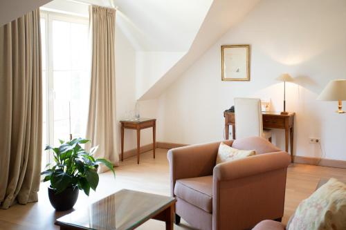 a living room with a couch and a chair at Hotel Restaurant Krone in Hayna