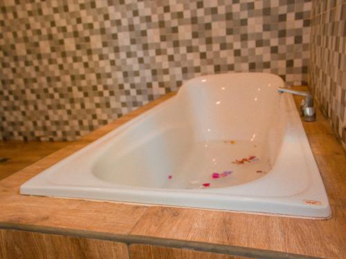 a bath tub with sprinkles in it in a bathroom at The Winaposa in Munduk
