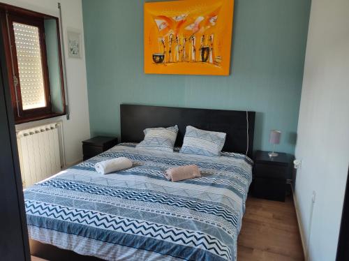 a bed with two pillows on it in a bedroom at House with pool and garden in Esmoriz near Porto in Esmoriz