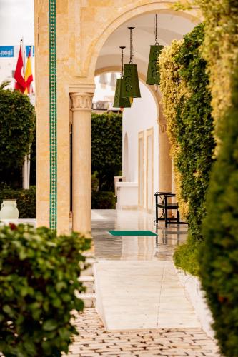 an archway of a building with green plants and lights at TMK Flora Park by Turismark - Adults Only in Hammamet