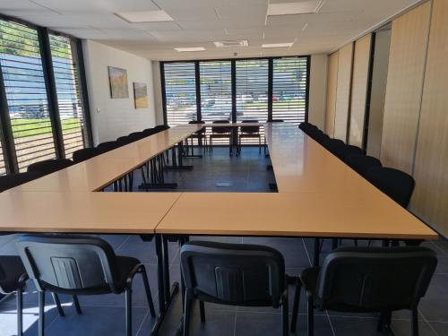 a long conference room with tables and chairs at Akena Molinges - La Brocatelle in Saint-Claude
