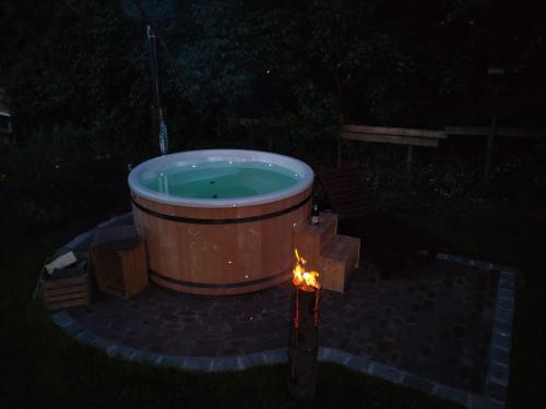 a hot tub with a fire in a yard at night at Ferienhof- Eiderdeich Whg. 3 Edith in Delve