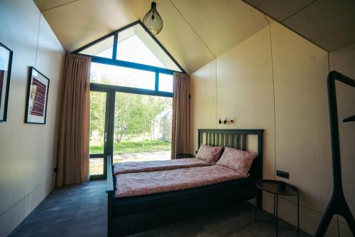 A bed or beds in a room at Apartamenti Vējdzirnavas