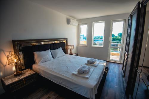 a bedroom with a bed with towels on it at Modern Spacious 1BD Apartment for two in Nesebar in Nesebar