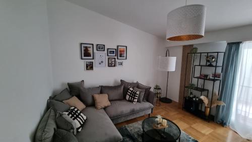 a living room with a couch and a table at Formin - Lux Apartment in Zadar