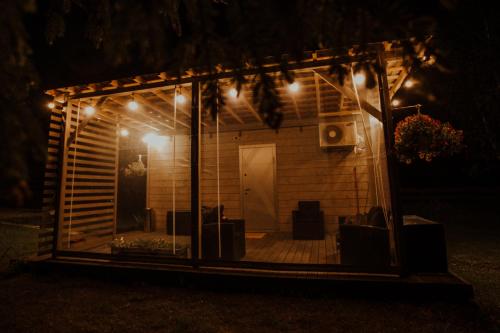 a house with a screened in porch at night at Mirror house in Tīnūži