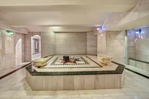 a large room with a tub in the middle of the room at Legacy Ottoman Hotel in Istanbul