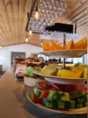 a buffet with fruits on plates on a table at Hemavans Wärdshus in Hemavan