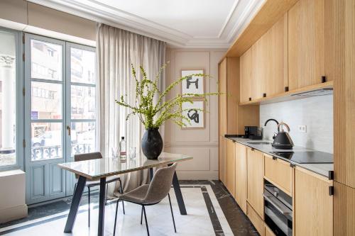 a kitchen with a table and a vase with flowers on it at Ayala 63 - THE ARC COLLECTION in Madrid