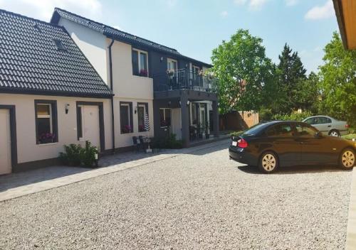 a car parked in front of a house at Holdudvar Apartman in Gyula
