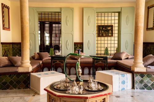 a lobby with couches and a table with a vase at TMK Flora Park by Turismark - Adults Only in Hammamet