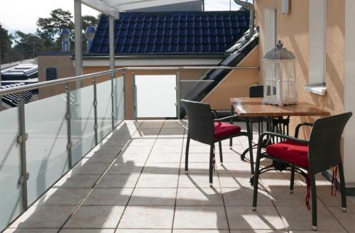 a patio with a table and chairs on a balcony at Ferienwohnung Baabe Jack Sparrow Ref. 189689-2 in Baabe