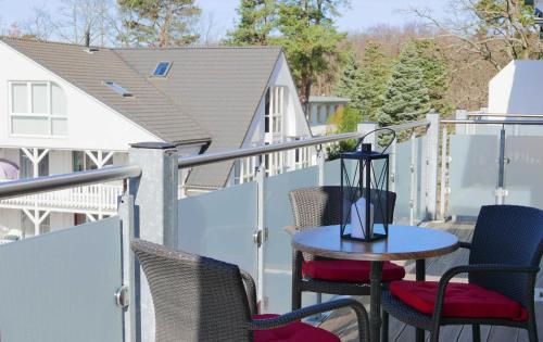 a patio with chairs and a table on a balcony at Ferienwohnung Baabe Jack Sparrow Ref. 189689-2 in Baabe