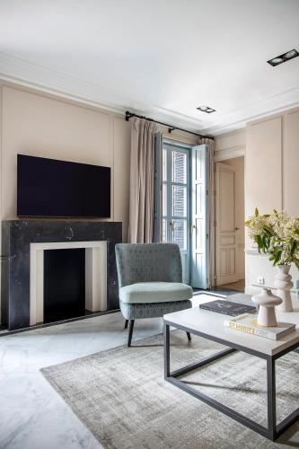 a living room with a chair and a fireplace at Ayala 63 - THE ARC COLLECTION in Madrid