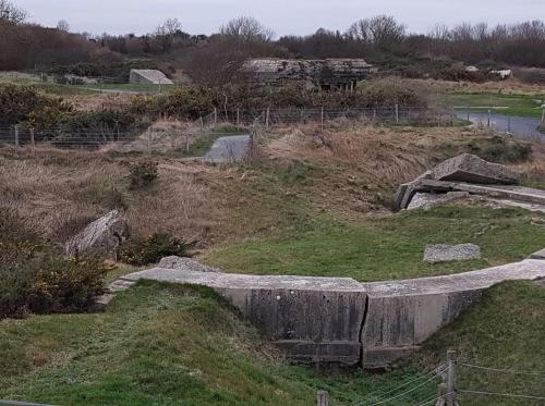 an empty field with a fence and some grass at le bonheur des plumes in Montmartin-en-Graignes