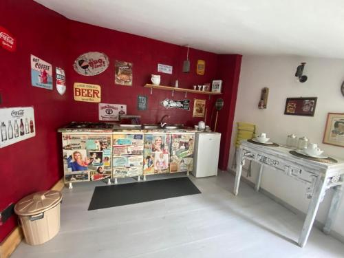 a kitchen with red walls and a table and a counter at Mansarda 13 in Salerno