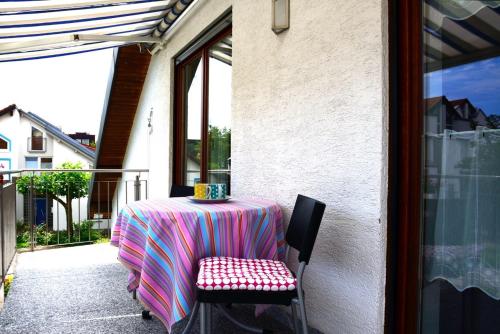 a table with a pink and purple table cloth on it at Ferienwohnung Bart in Friedrichshafen