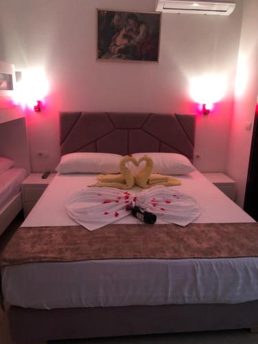 a person is laying on a bed with a plate at Vila Xhafa in Ksamil