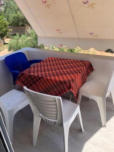 a blanket on a table and chairs on a patio at Vila Xhafa in Ksamil