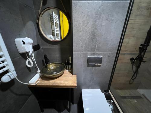 a small bathroom with a sink and a mirror at Gudauri Loft Hotel in Gudauri