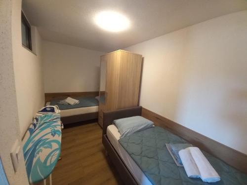 a small room with two beds and a cabinet at Apartment Ana in Tar